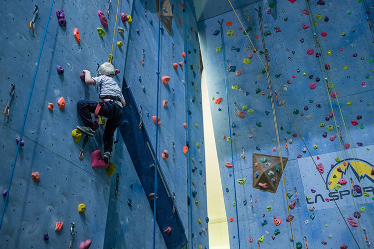 Young boy wall climbing