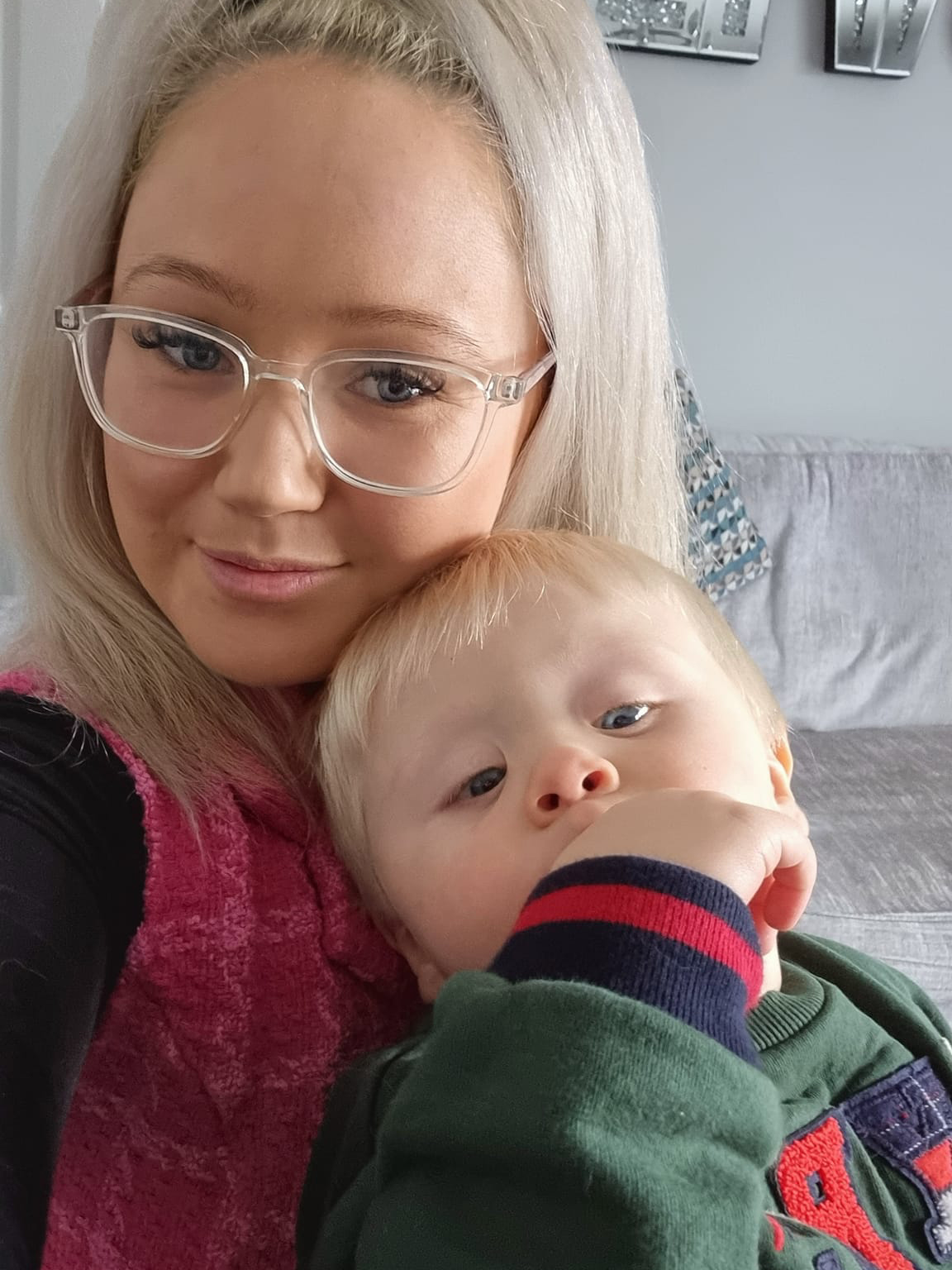 Sophie, with blonde hair and glasses, and her little boy Frankie, with blonde hair and a green, blue and red jumper 