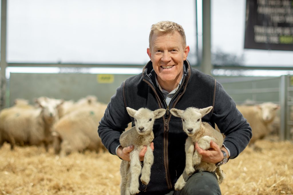 Adam Henson poses with newborn lambs
